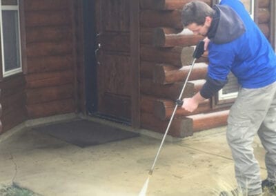 Person cleaning the floor with power washer