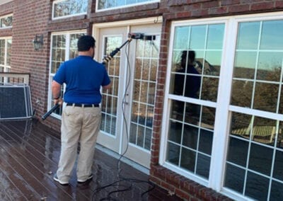 Window washer cleaning the glass doors
